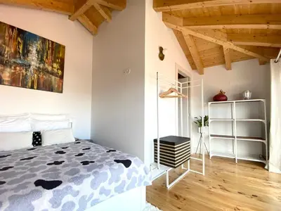 a bedroom with a bed and a painting on the wall at VIVA - Rooftop Terrace View Flat in Porto