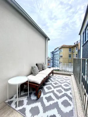 an apartment balcony with a couch and a table at VIVA - Rooftop Terrace View Flat in Porto