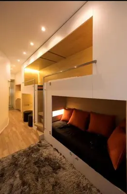 a bedroom with a bunk bed with orange pillows at Space Shuttle studios - Tiny House in Porto