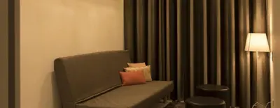 a room with a chair with a pillow on it at Space Shuttle studios - Tiny House in Porto