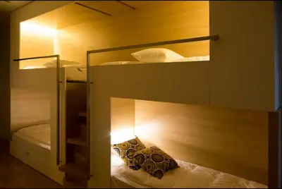 a room with two bunk beds with a light at Space Shuttle studios - Tiny House in Porto