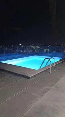 a large swimming pool at night with a city at New Douro 403 with parking in Vila Nova de Gaia