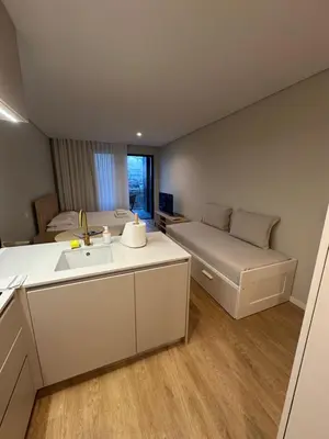 a small room with a sink and a couch at New Douro 403 with parking in Vila Nova de Gaia