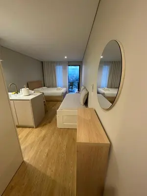 a bedroom with a bed and a mirror and a sink at New Douro 403 with parking in Vila Nova de Gaia