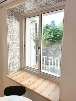 a window with a view of a balcony at Casa Moara - Downtown Duplex House in Porto