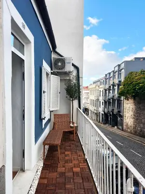 a balcony with a bench on the side of a building at Casa Moara - Downtown Duplex House in Porto