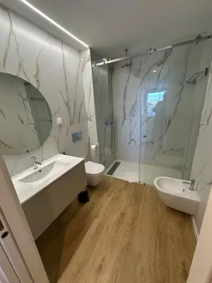 a bathroom with a sink and a toilet and a mirror at New Douro 406 with parking in Vila Nova de Gaia