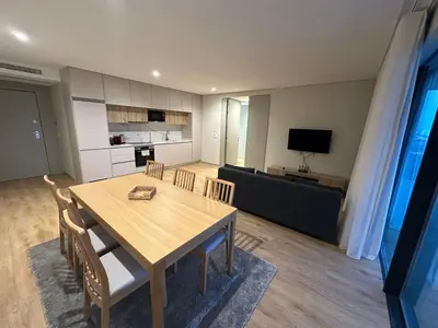 a kitchen and living room with a couch and a table at New Douro 801 with parking in Vila Nova de Gaia