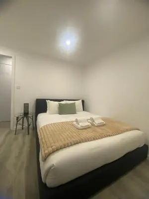 a bedroom with a bed with two towels on it at Porto Saldanha - 2x T2 Duplex in Porto