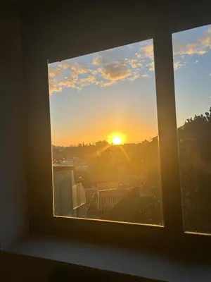 a window with a view of the sunset at Porto Saldanha - 2x T2 Duplex in Porto