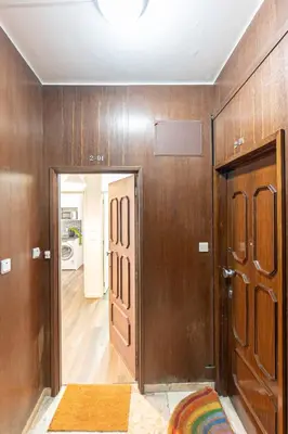 a room with wooden walls and a door and a hallway at Now Trindade in Porto