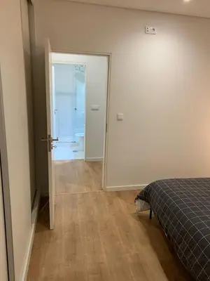 a bedroom with a door leading to a bathroom at A melhor estadia do Porto in Porto