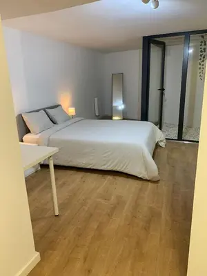 a bedroom with a large bed and a table at A melhor estadia do Porto in Porto