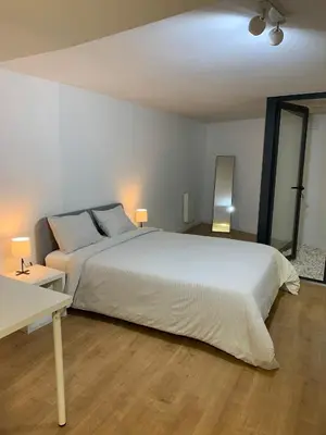 a bedroom with a large white bed with two lamps at A melhor estadia do Porto in Porto
