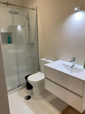 a bathroom with a shower and a toilet and a sink at A melhor estadia do Porto in Porto