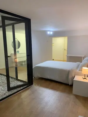 a bedroom with a bed and a large mirror at A melhor estadia do Porto in Porto