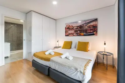 a bedroom with a large bed with yellow pillows at GuestReady - Homey experience in Porto in Porto