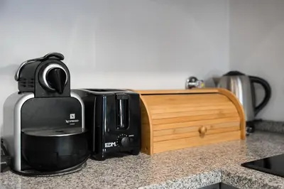 a kitchen counter with a coffee maker and a microwave at GuestReady - Homey experience in Porto in Porto