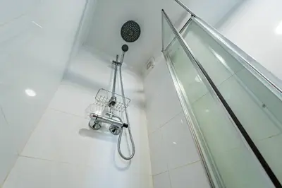 a shower with a shower head in a bathroom at Essence Oporto Apartment Downtown in Porto