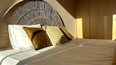 a bed with two pillows on top of it at BEST - Apartment with AC, Parking and Balcony in Porto