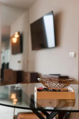 a glass table with a bowl on top of it at BEST - Apartment with AC, Parking and Balcony in Porto