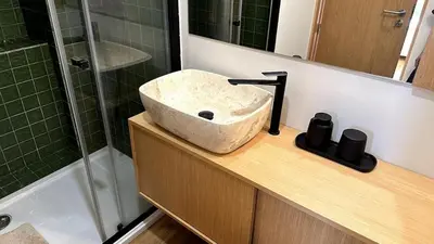 a bathroom with a stone sink and a shower at BEST - Apartment with AC, Parking and Balcony in Porto
