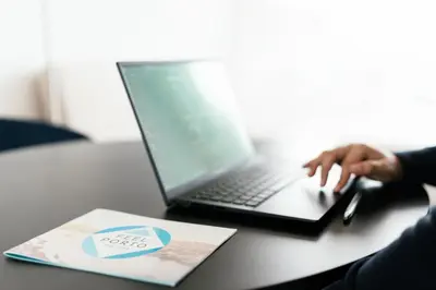 a person sitting at a desk with a laptop computer at Feel Porto Lapa Collection Flats in Porto