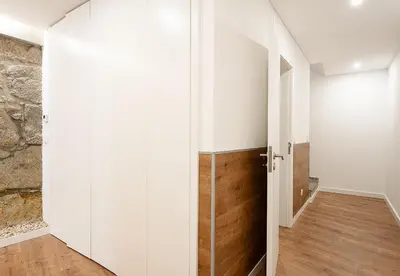 a room with white walls and a sliding door at Feel Porto Lapa Collection Flats in Porto