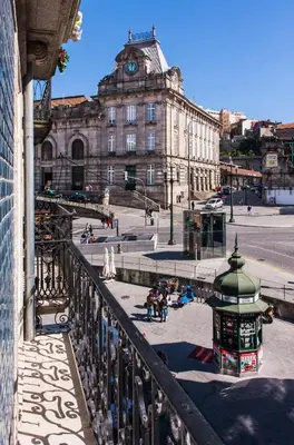 a view from a balcony of a building with a clock tower at Cardosas Charming Apartment with Balconies in Porto
