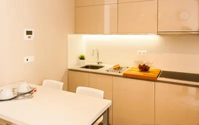 a kitchen with a sink and a table with chairs at Cardosas Charming Apartment with Balconies in Porto