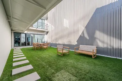 a patio with benches and a table and chairs at GuestReady - Silk Factory Studios and Apartments in Porto