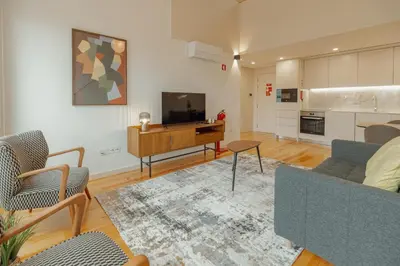 a living room with a couch and a television at Gaia Premium Apartments by Vacationy in Porto