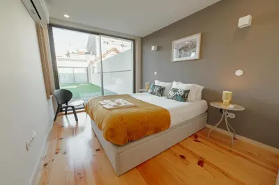 a bedroom with a large bed and a large window at Gaia Premium Apartments by Vacationy in Porto