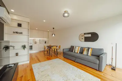 a living room with a couch and a table at Gaia Premium Apartments by Vacationy in Porto