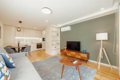 a living room with a couch and a table at Gaia Premium Apartments by Vacationy in Porto