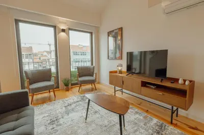 a living room with a tv and a couch at Gaia Premium Apartments by Vacationy in Porto
