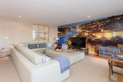 a living room with a white couch and a large painting at Local 167 - Oporto View House in Vila Nova de Gaia