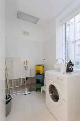 a white washing machine in a white room with a window at Local 167 - Oporto View House in Vila Nova de Gaia