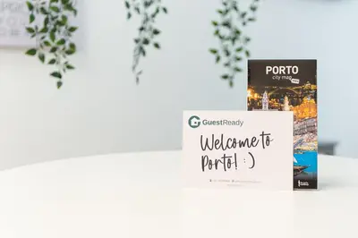 a book sitting on top of a table next to a table at GuestReady - Fabric Porto Apartment in Porto