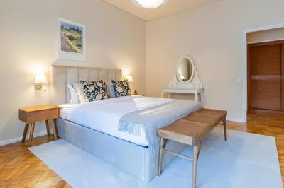 a bedroom with a large bed and a table at 3BR Joyous Wonder by LovelyStay in Porto