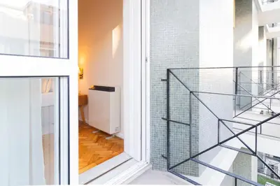 a glass staircase leading to the second floor of a building at 3BR Joyous Wonder by LovelyStay in Porto