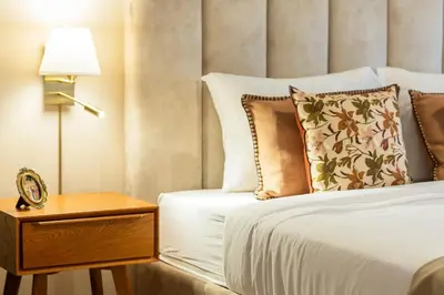 a hotel room with a bed and a nightstand with a clock at 3BR Joyous Wonder by LovelyStay in Porto