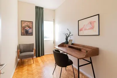 a living room with a desk and a chair at 3BR Joyous Wonder by LovelyStay in Porto