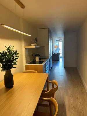 a kitchen with a wooden table and a dining room at Largo São Domingos by Innapartments in Porto