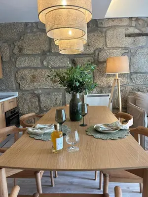 a wooden table with wine glasses and a vase at Largo São Domingos by Innapartments in Porto