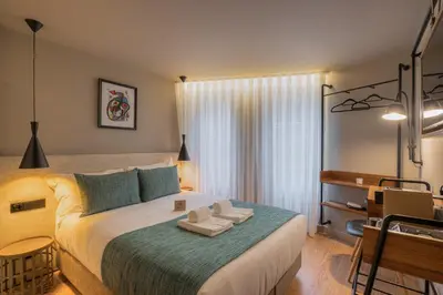 a bedroom with a large bed with towels on it at Carpe Diem Porto By Dualgroup in Porto