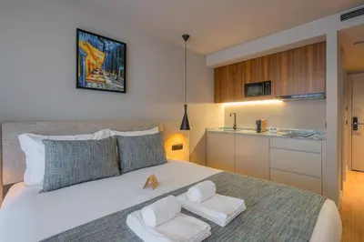 a bedroom with a large white bed with two white towels at Carpe Diem Porto By Dualgroup in Porto