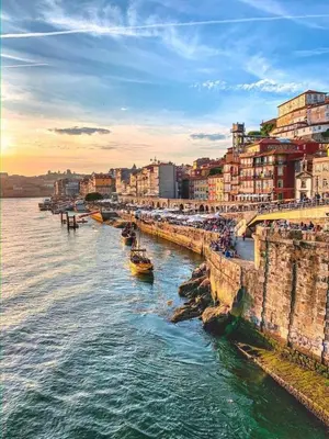 a chair sitting on a balcony next to a stone wall at Oasiys - Your Getaway in Porto in Porto