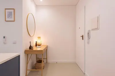 a white room with a table and a mirror at DoisPontoZero NAVY in Porto
