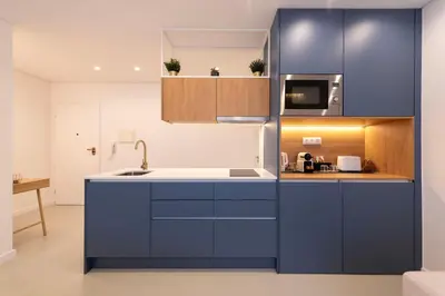 a kitchen with blue cabinets and a sink at DoisPontoZero NAVY in Porto